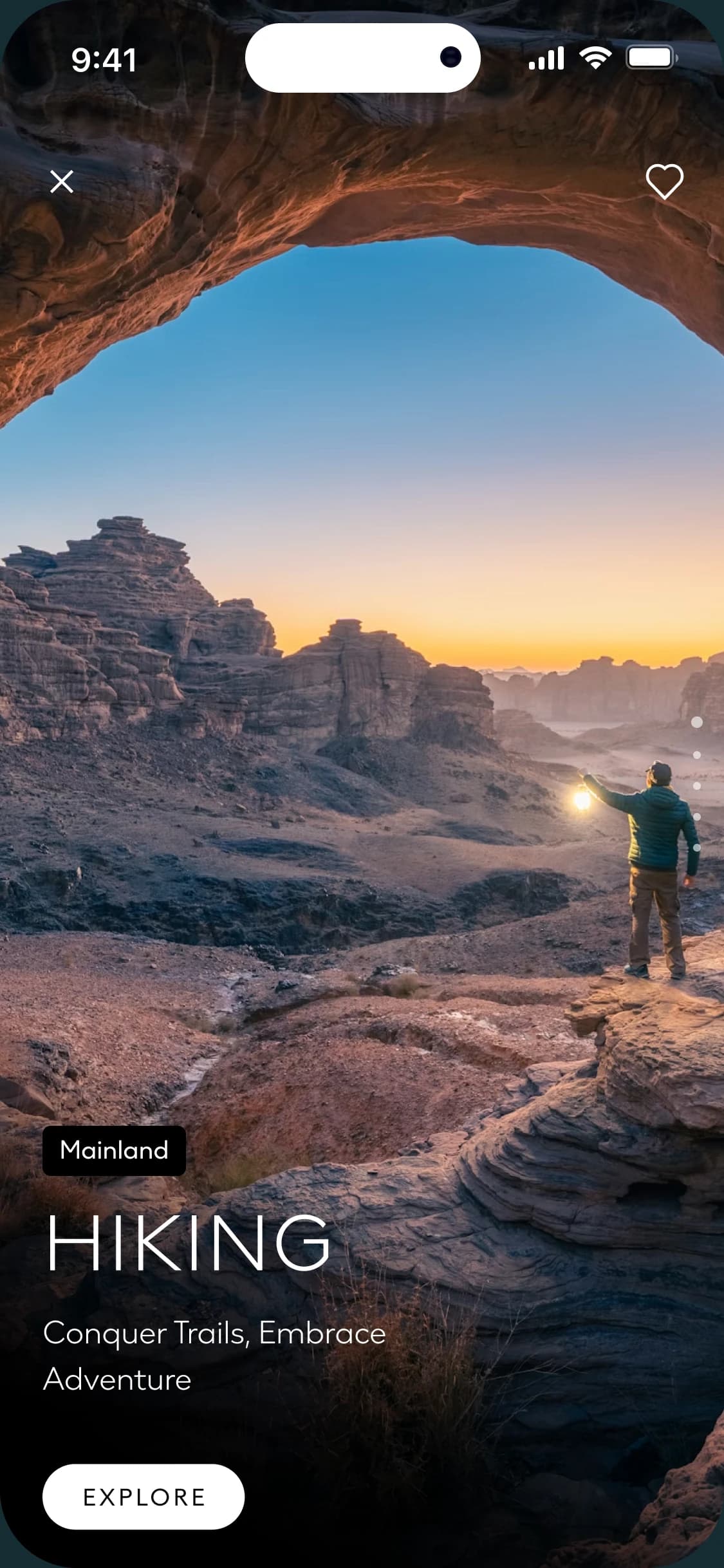 NEOM app screen showing a hiker with a lantern beneath a rock arch at sunrise, tagged Mainland and titled Hiking